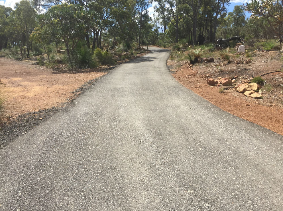 This is a photo of a hot spray & seal bitumen driveway which is in the process of being installed by Mulgrave Surfacing Solutions